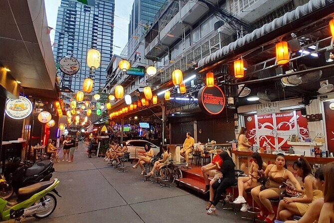 Bangkok nightlife’s secrets… - Stop 2: Soi Cowboy warm-up under neon signage
