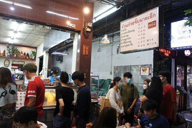 Chinatown Street Food Night Tour by Tuk Tuk in Bangkok - Wat Ratchanatdaram and Grand Palace exterior views: glowing landmarks without the long wait